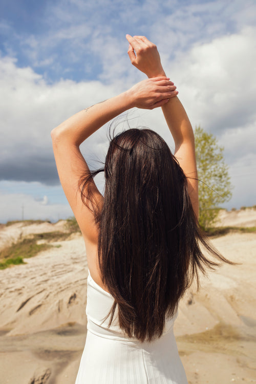 black hair extensions - model at the beach