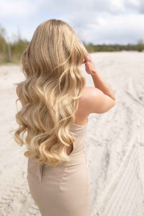 model with blond tape in hair extensions 55 cm